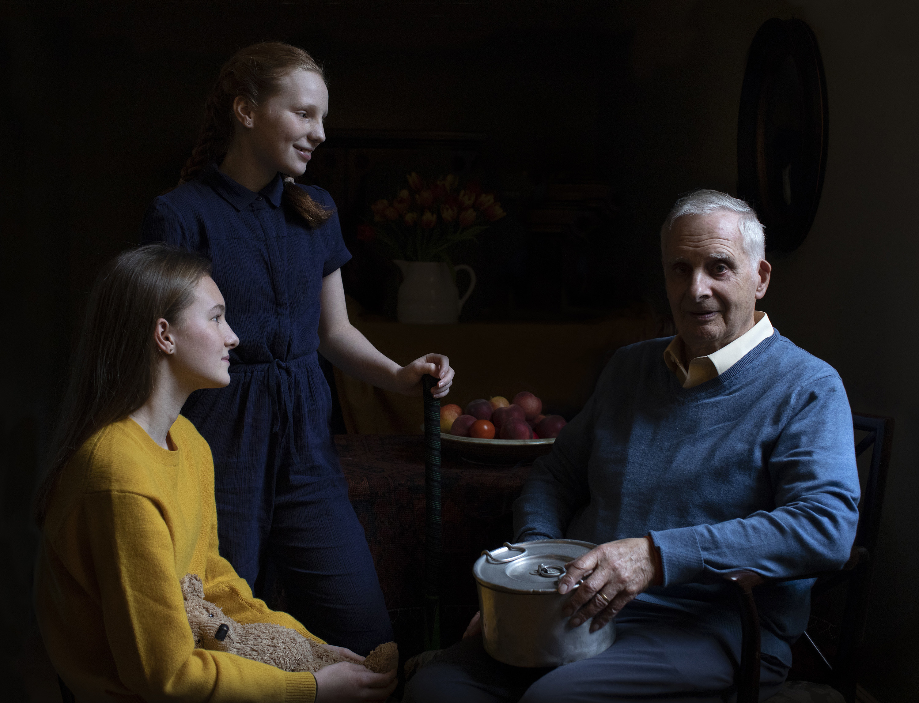 Concentration camp survivor Steven Frank, 84, sits with his granddaughters, Maggie and Trixie