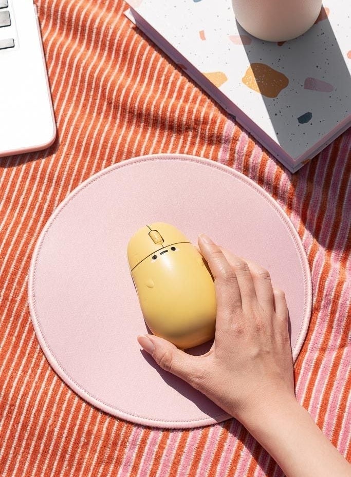 hand reaching for mouse that looks like a potato with face and arms