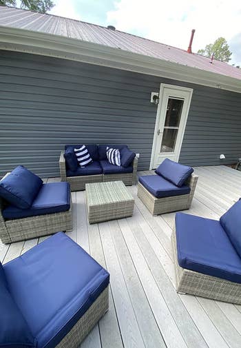 another reviewer photo of blue modular sectional in separated in all the different pieces on a large deck