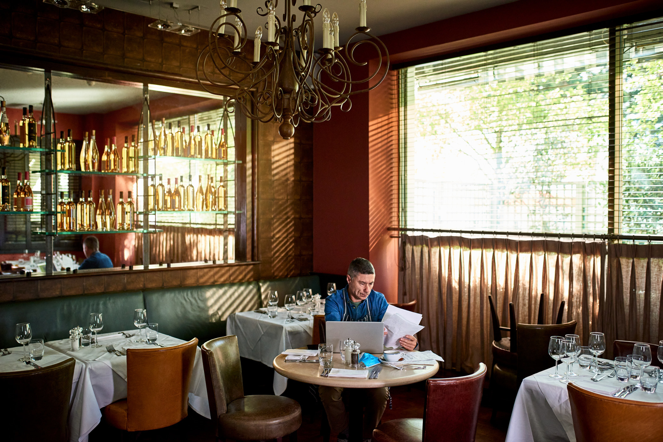 Business owner in restaurant checking paperwork