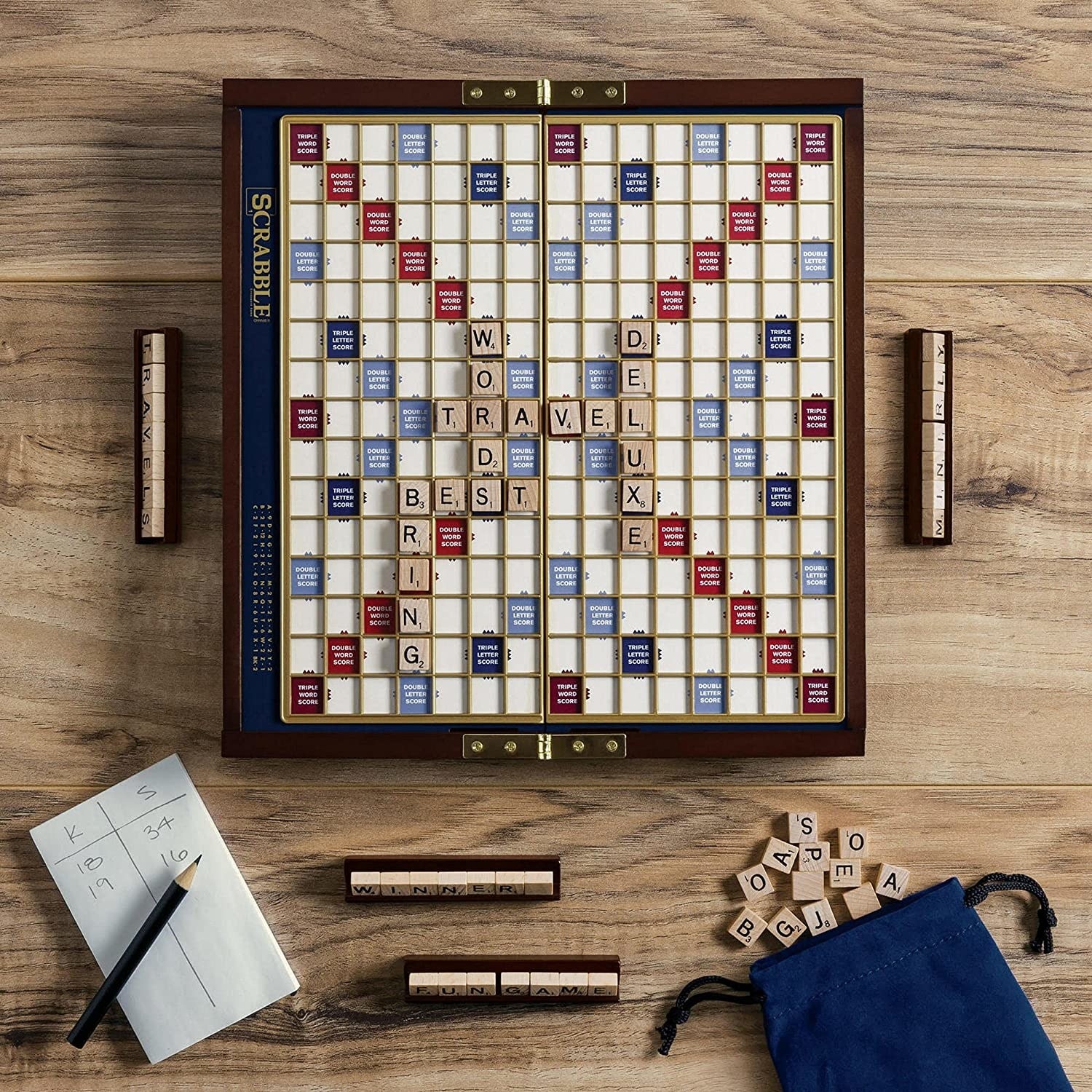 portable scrabble board game with a few tiles and words on it