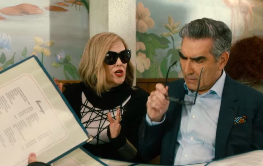 Moira talking to Johnny as they sit together in the cafe in &quot;Schitt&#x27;s Creek&quot;
