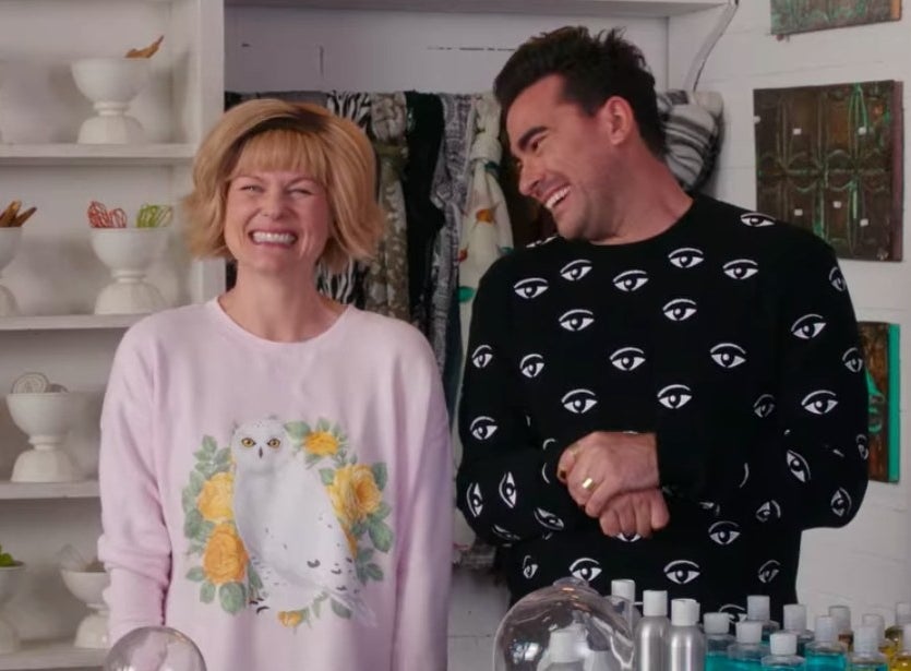 Jocelyn smiling with Dave smiling at her in Rose Apothecary in &quot;Schitt&#x27;s Creek&quot;