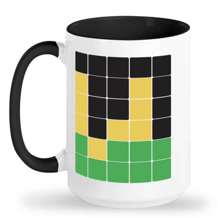 tall mug with green, yellow, and black squares on it