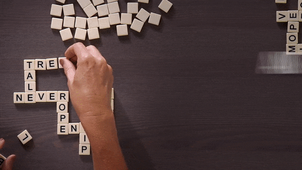gif of someone putting together a bananagrams grid