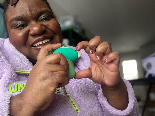 Reviewer making a heart with hand and suction toy