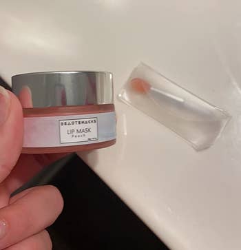 Reviewer holding lip mask next to applicator