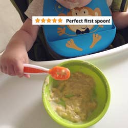 reviewer's child using the spoon to eat oatmeal from a bowl with the words 