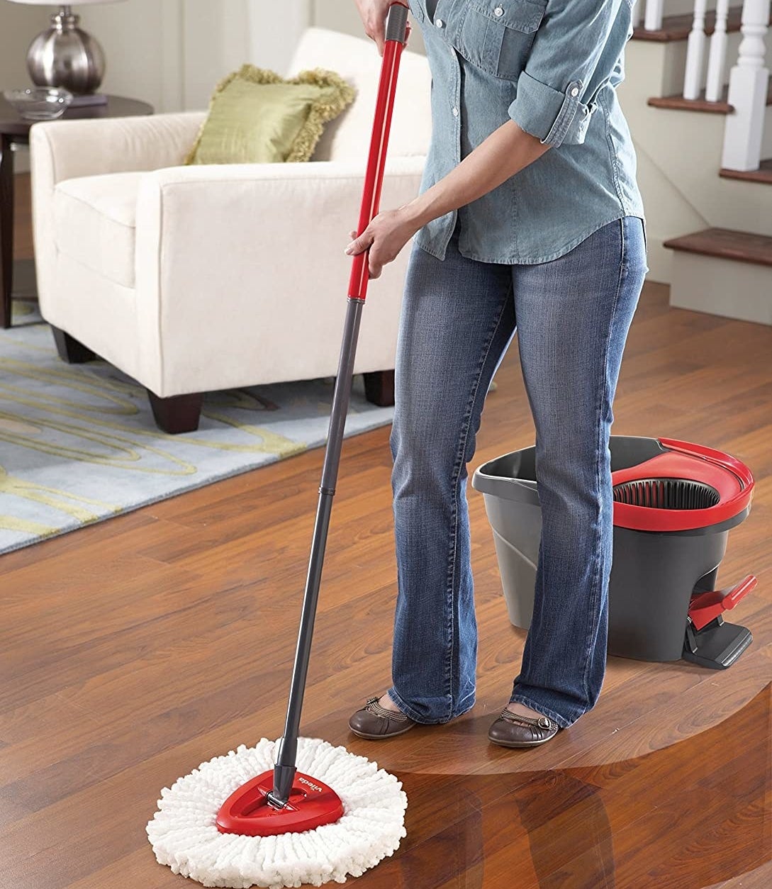 A person using the mop on their hardwood floors