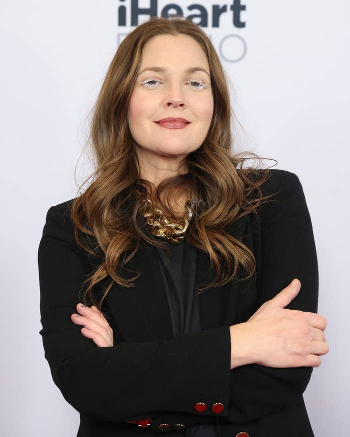 Barrymore poses with her arms crossed