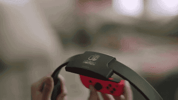 A Gif of a person sliding their controller into the ring and then jogging