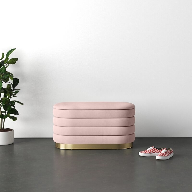 The upholstered storage bench in blush pink