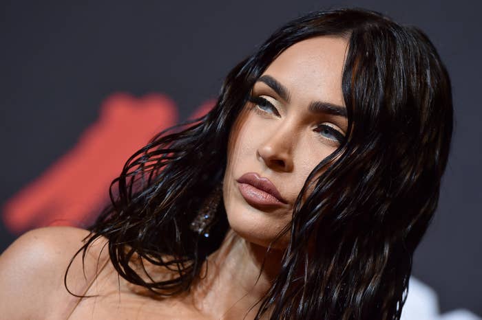 Megan at a red carpet event with her hair down in a wet-and-wavy look