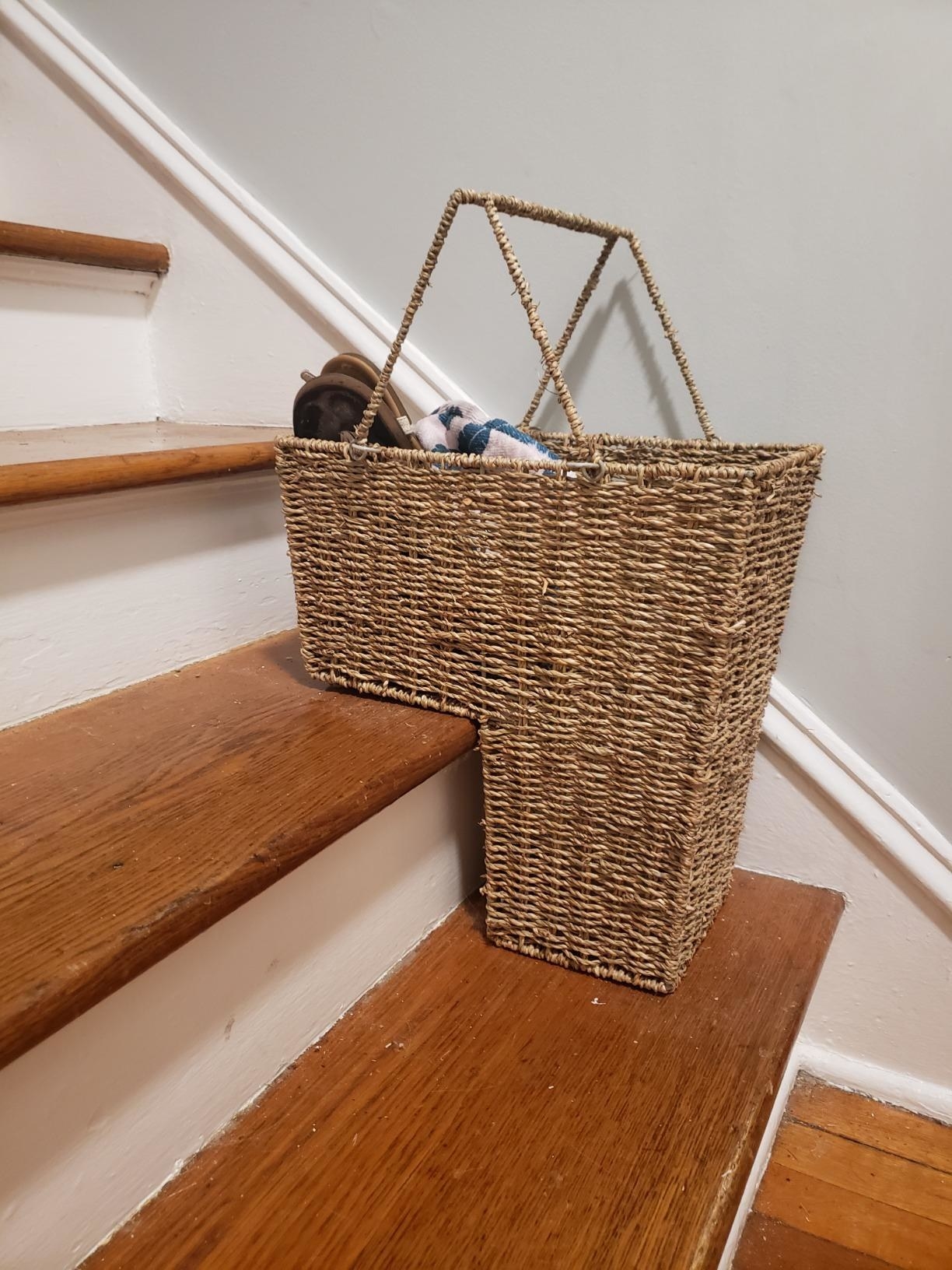 the two tier wicker basket, which is shaped like an L and sits on two steps