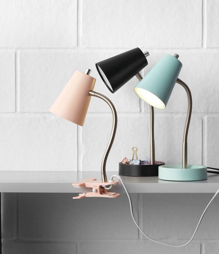 A black, pink and blue lamp in a room