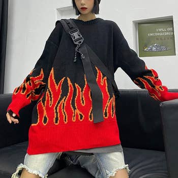 same model wearing the sweater in black and red