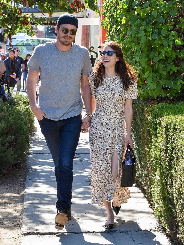 Garrett and Emma walking outside hand-in-hand