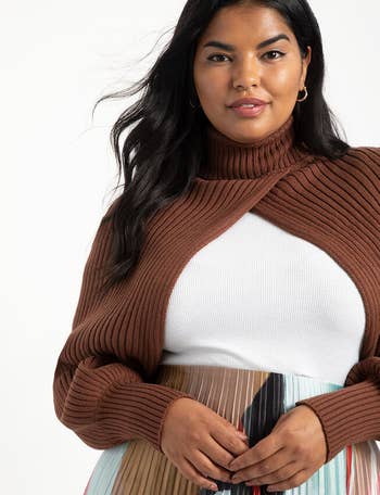 a different model wearing the brown sweater over a white top