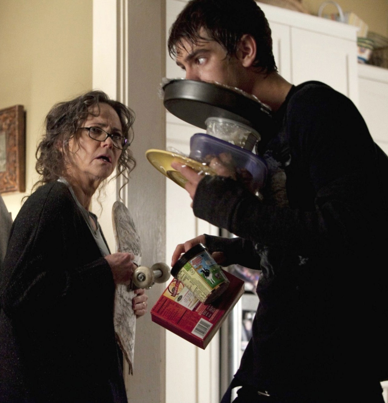 May watches in disgust as Peter carries an armload of snacks to his room