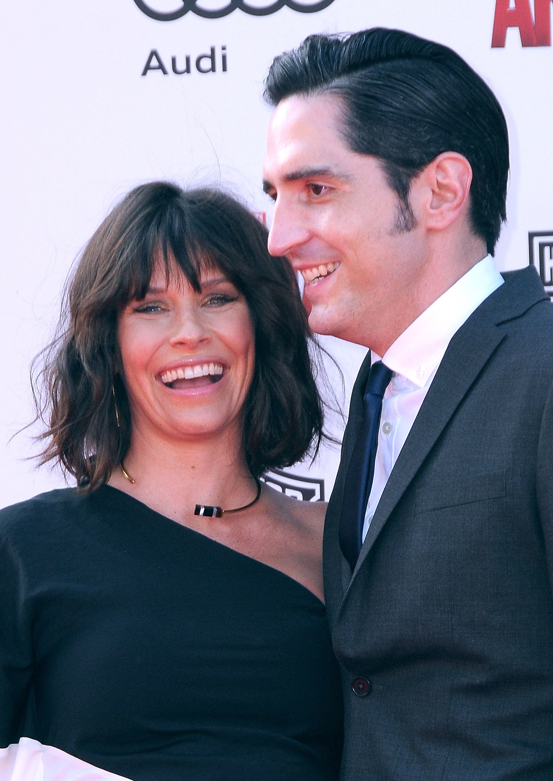 David and Evangeline smiling together at a red carpet event