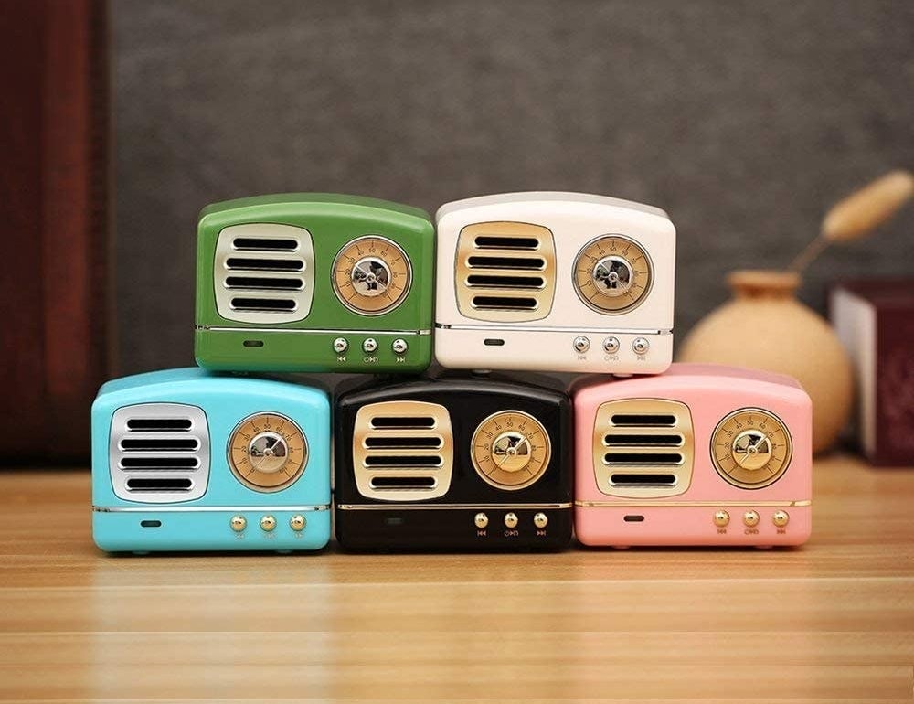 stack of mini retro speakers in blue, black, pink, green, and white