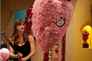 Jennifer Garner as Julia Fitzpatrick holds a bat in front of a heart shaped piñata in "Valentine's Day"