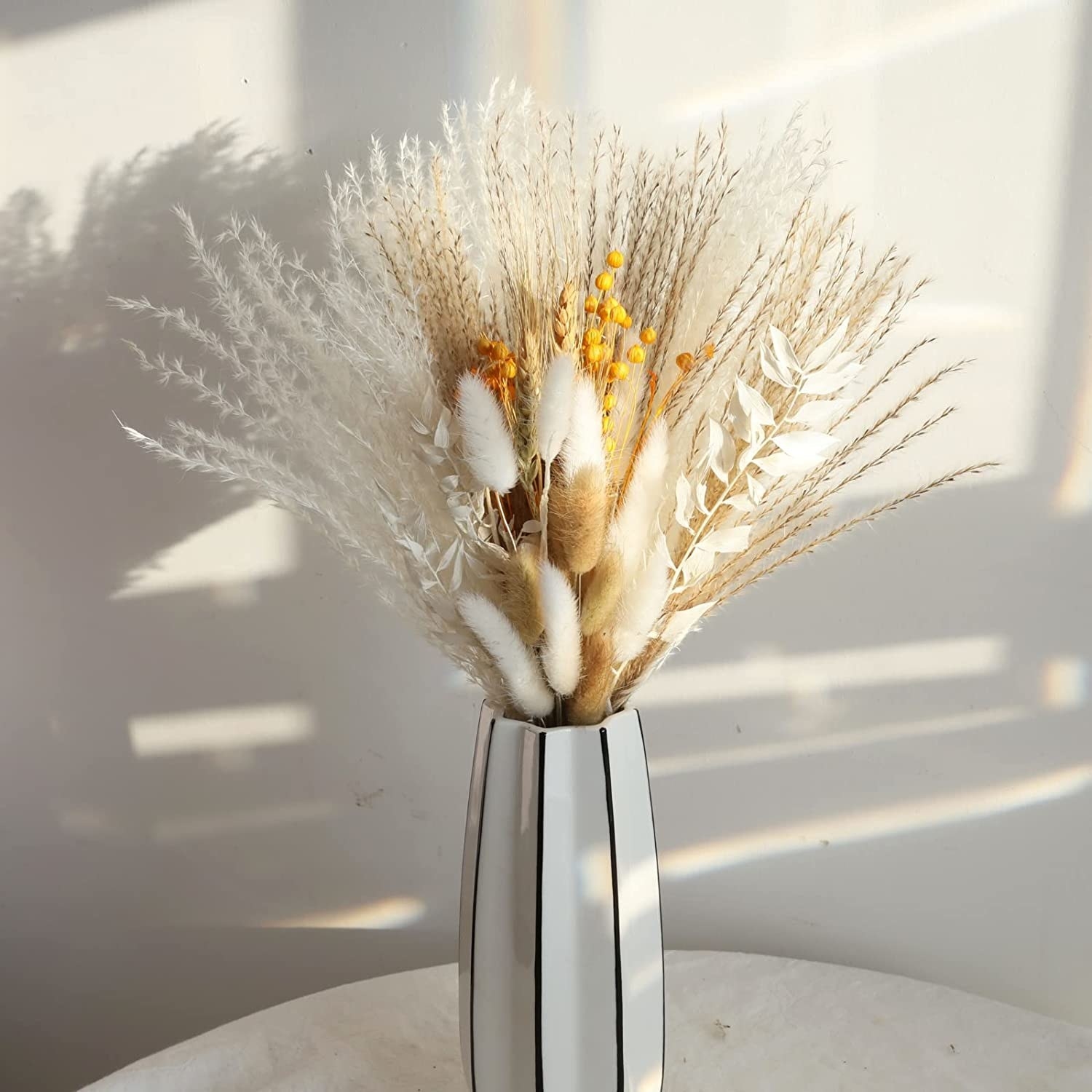 Dried bouquet arrangement in a white vase