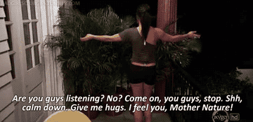 Gif of woman hugging plants and saying &quot;are you guys listening? no? come on you guys, stop. calm down. give me hugs. i feel you, mother nature.&quot;