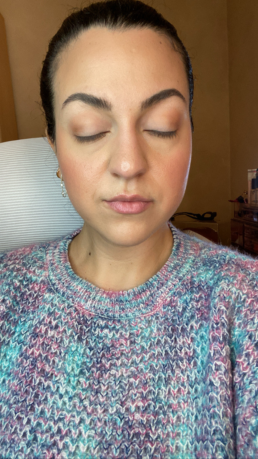 A selfie of the author with her eyes closed showing off her eye makeup