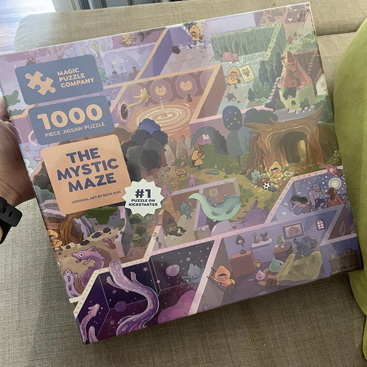 a reviewer photo of the reviewer holding the puzzle box