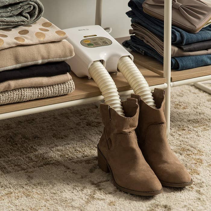 a shoe dryer with tubes inserted into the tops of boots