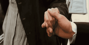 Mr. Darcy flexing his hand after helping Elizabeth into the carriage