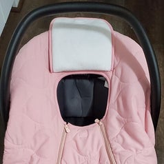 The car seat cover on a car seat with the head flap open
