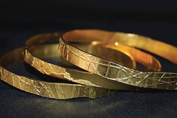 close up of the etching designs on three different bangles