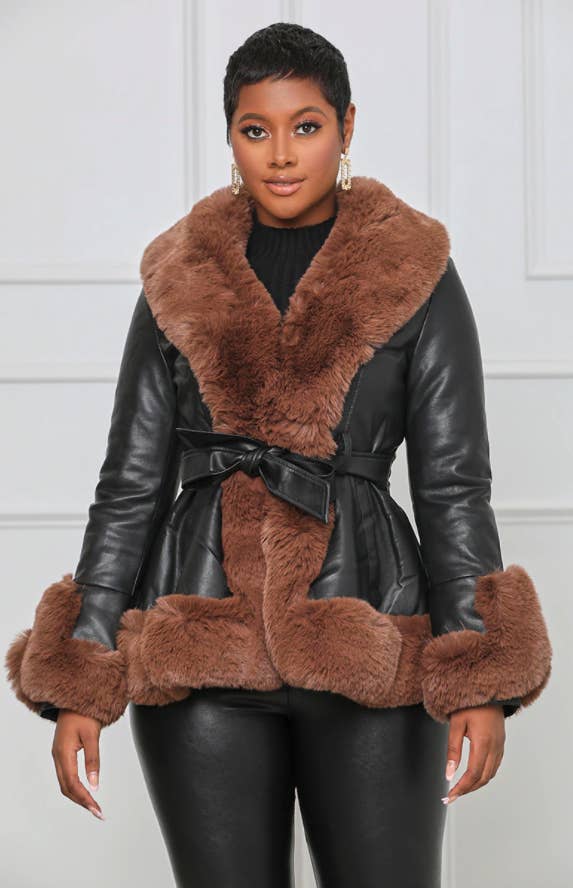 model wearing the black leather jacket with a brown faux fur trim