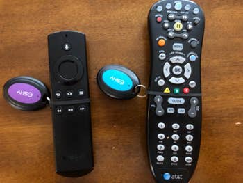 reviewer's photo showing the purple and blue receivers attached to two remotes