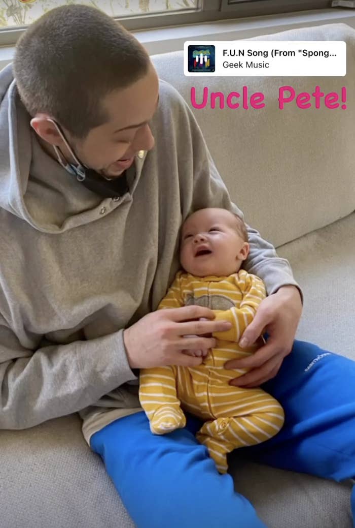 Pete holding a smiley Malcolm as he sits on a couch with the caption &quot;Uncle Pete!&quot;