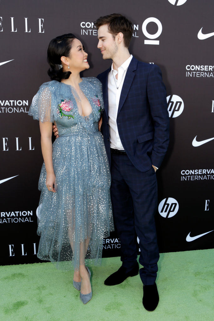 Lana and Anthony look at each other adorably as they stand as photographers take their picture at a red carpet event