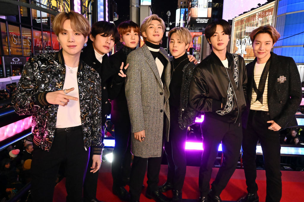 BTS posing for a photo onstage in Times Square