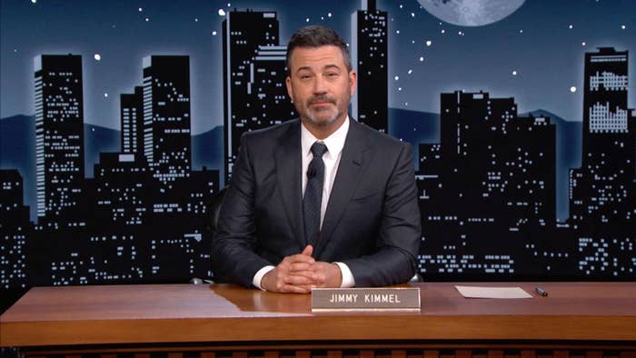 Jimmy sitting at his desk on his show