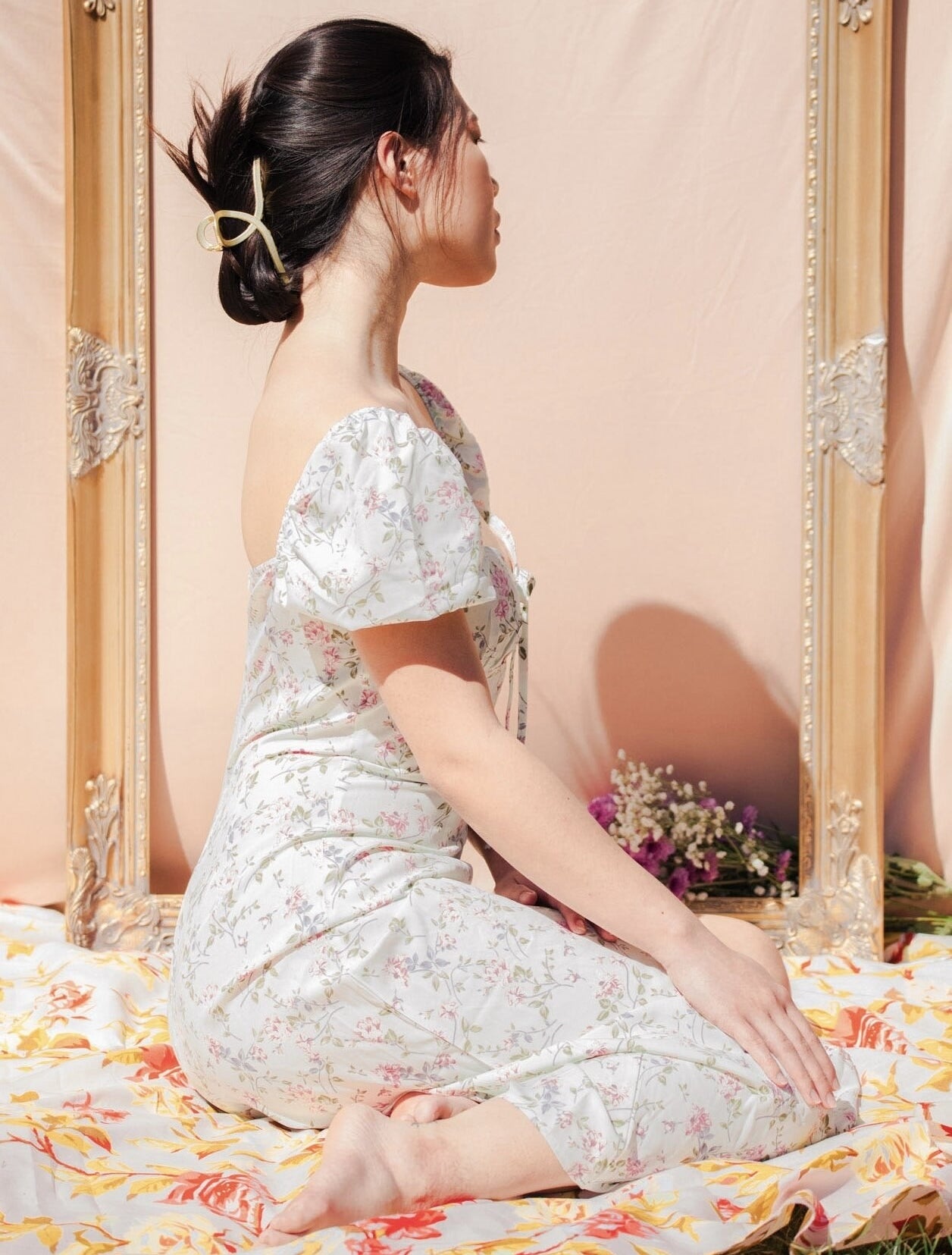 Model posing while wearing the gold loop claw clip
