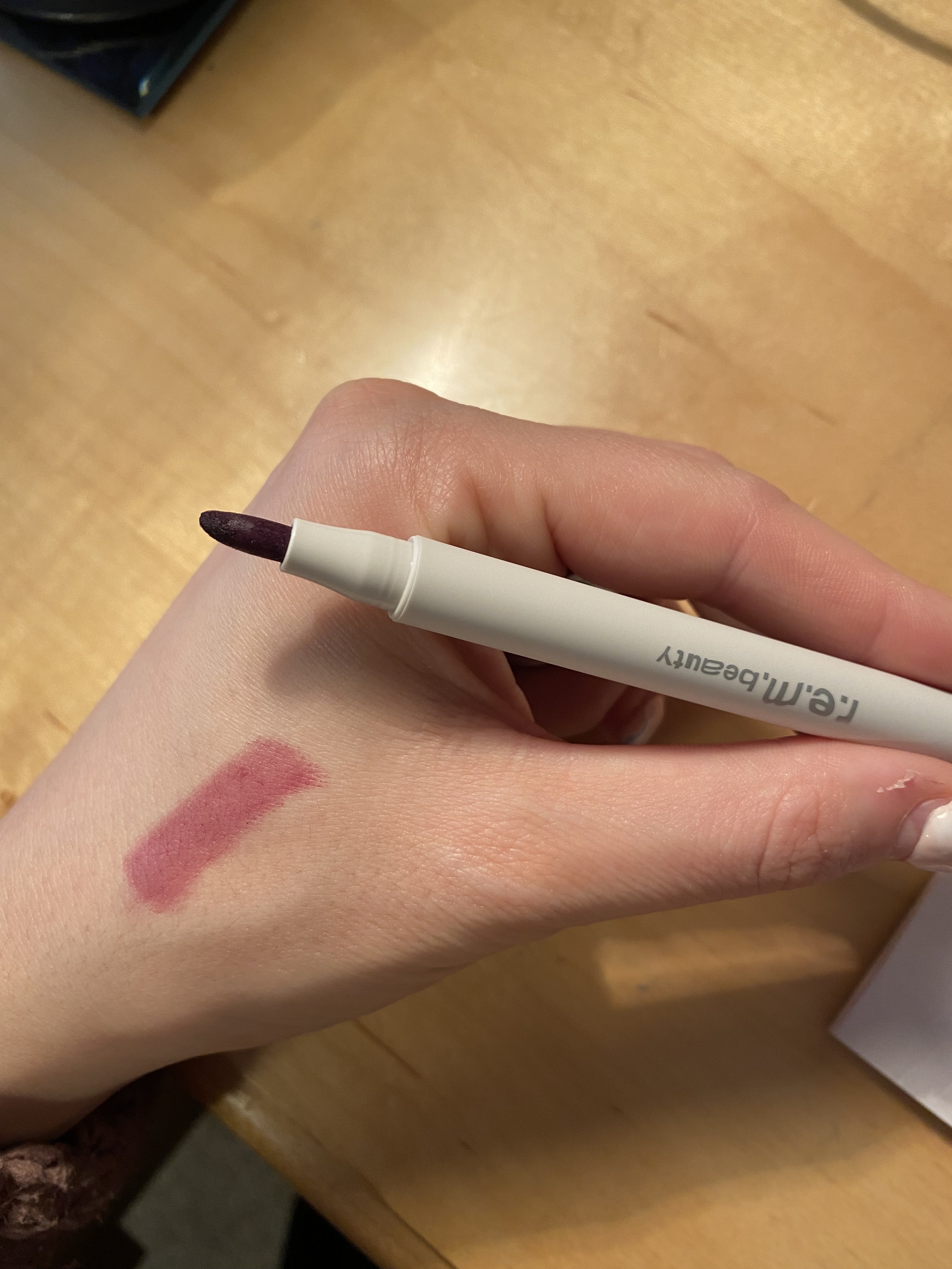 The lip maker samples on the author&#x27;s hand while she&#x27;s holding the actual marker