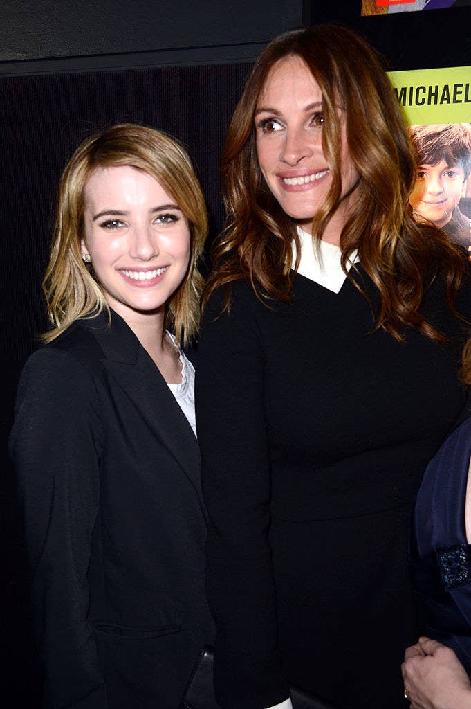 Emma and Julia smiling as the walk a red carpet at an event