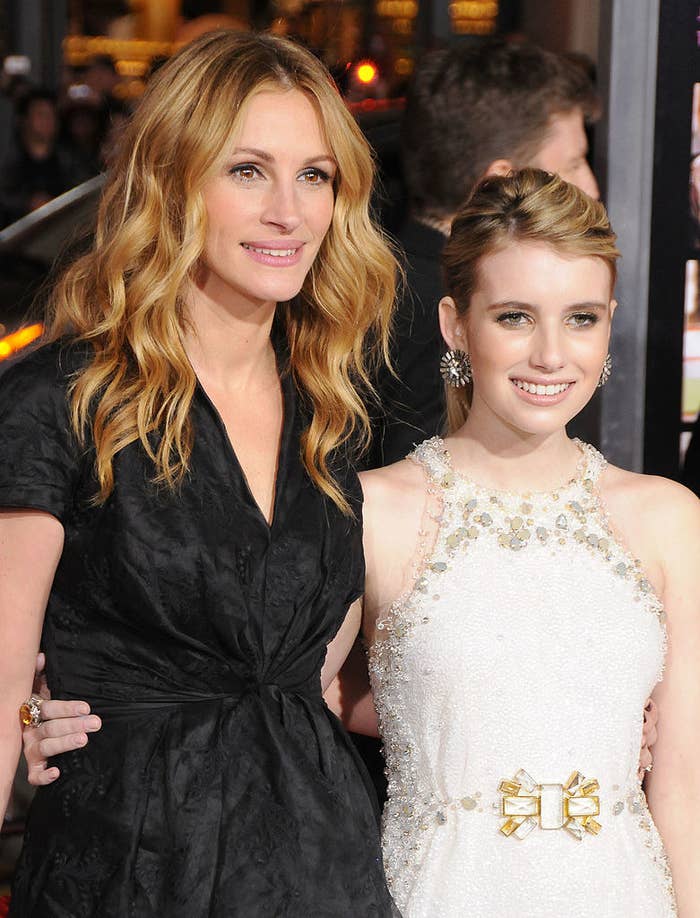 Julia and Emma posing together for photographers at a red carpet event