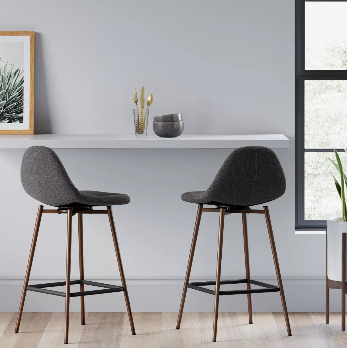 grey upholstered stools with wooden legs