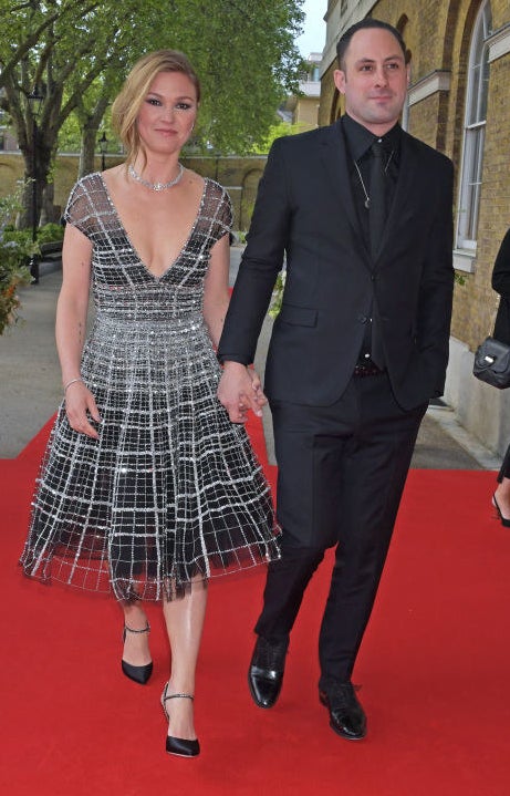 Julia (L) and Preston (R) walking hand-in-hand on the red carpet