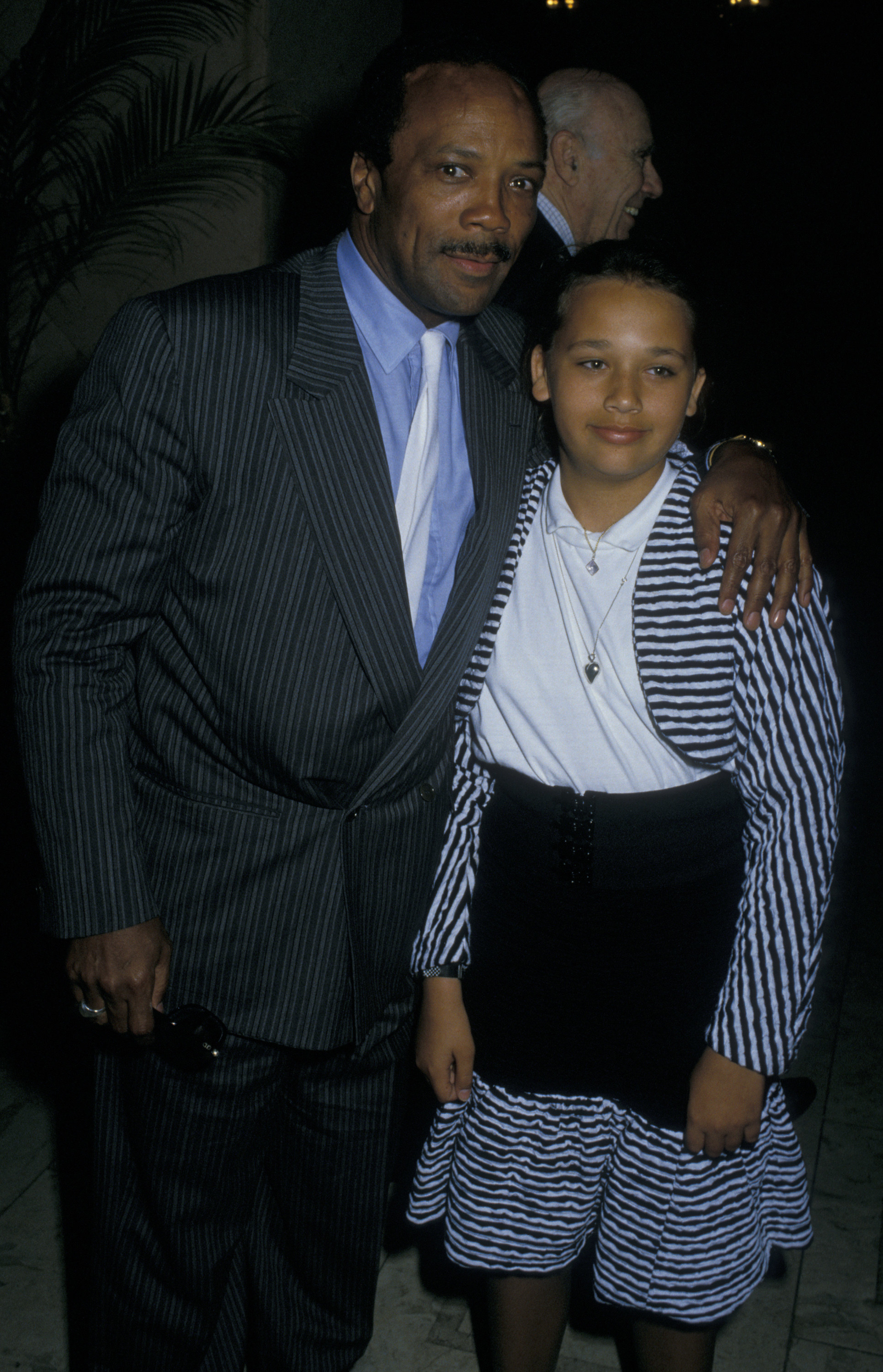 Quincy Jones and Rashida Jones posing for a photo at a hotel