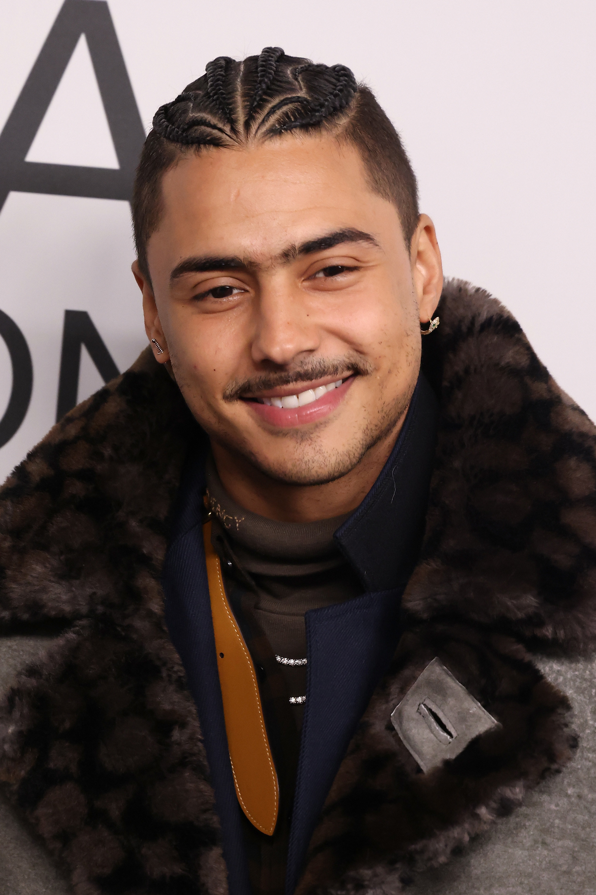 Quincy Brown smiling on a red carpet