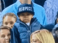 A kid taking off a cap saying,