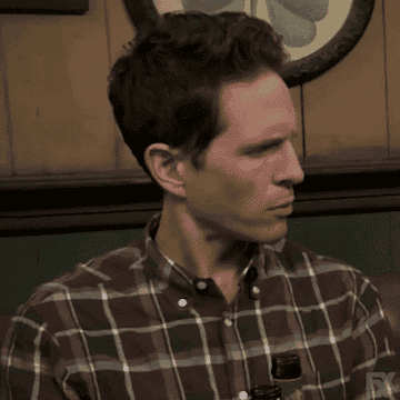Glenn Howerton as Dennis Reynolds raises his eyebrows and widens his eyes before looking away in